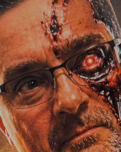 Rick Builds Apps portrait — one human eye behind glasses, one glowing red cyborg eye